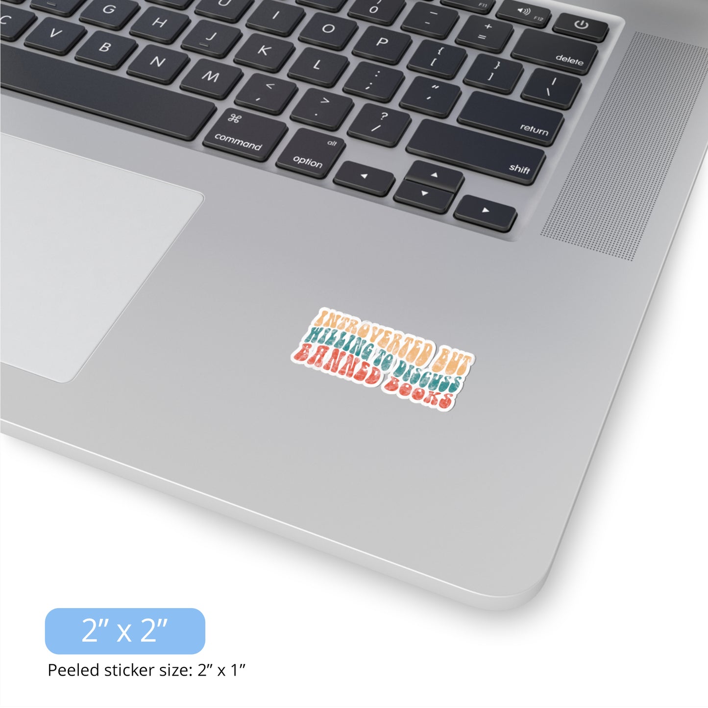 Contextual photo of the 2x2 inch (2x1” peeled) kiss-cut sticker that says “Introverted but willing to discuss banned books” in a retro, 1970s bubble font. Each line is a different color. The graphic is slightly distressed.