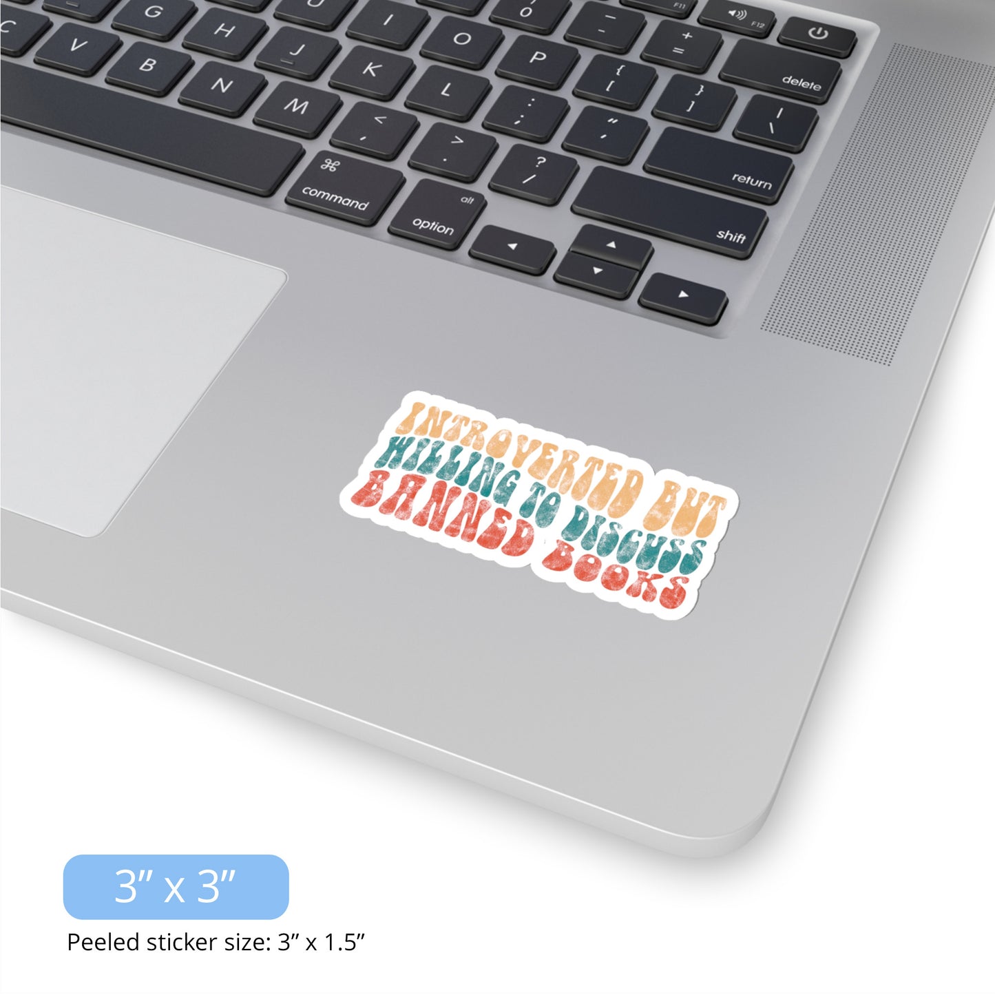 Contextual photo of the 3x3 inch (3x1.5” peeled) kiss-cut sticker that says “Introverted but willing to discuss banned books” in a retro, 1970s bubble font. Each line is a different color. The graphic is slightly distressed.