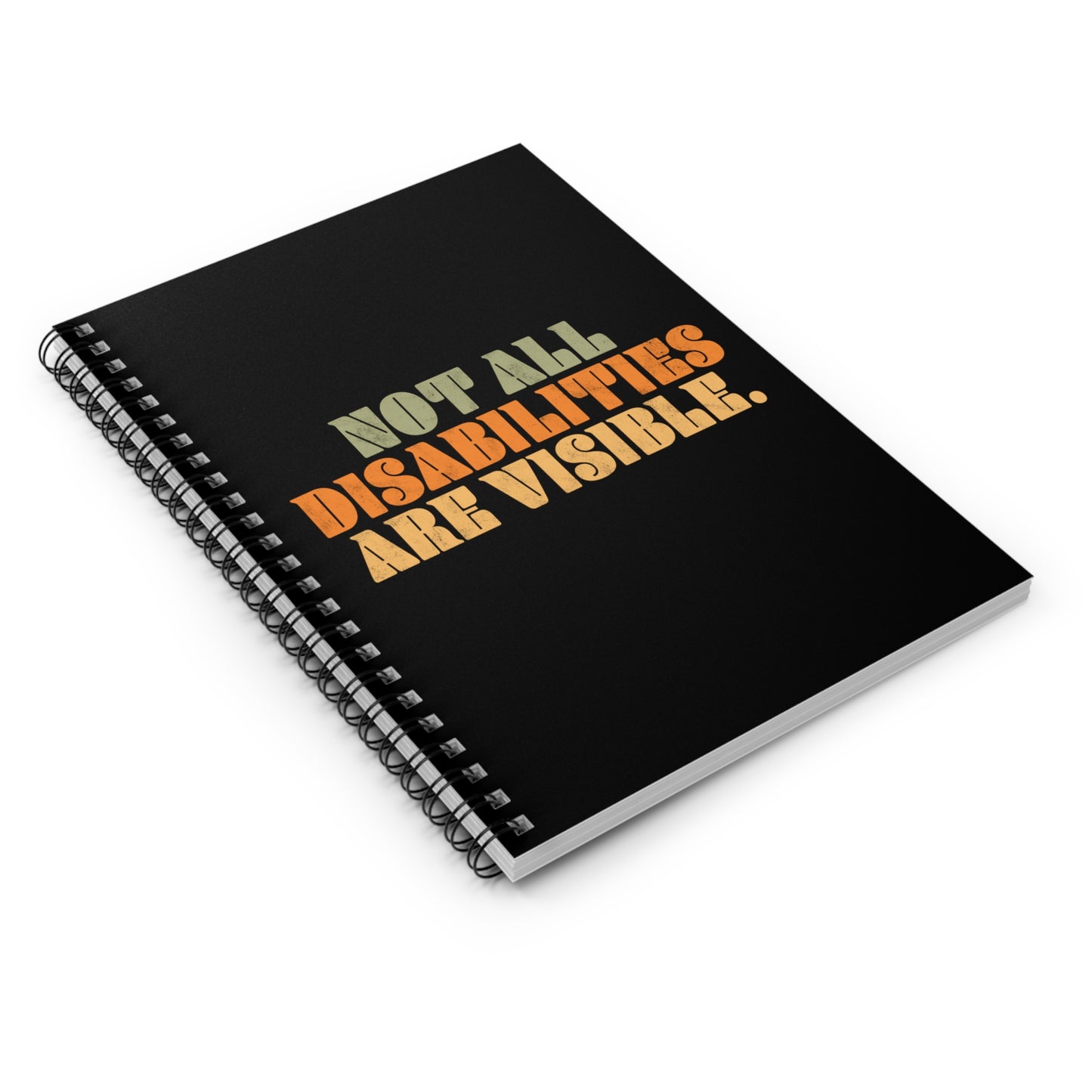 A black spiral notebook that says, “Not all disabilities are visible” in a thick, retro font in all caps. Each line is a different color. “Not all” is light green, “disabilities” is orange, and “are visible” is yellow. The graphic has a retro look and is slightly distressed. The mug is on a table with a spoon and a cookie.