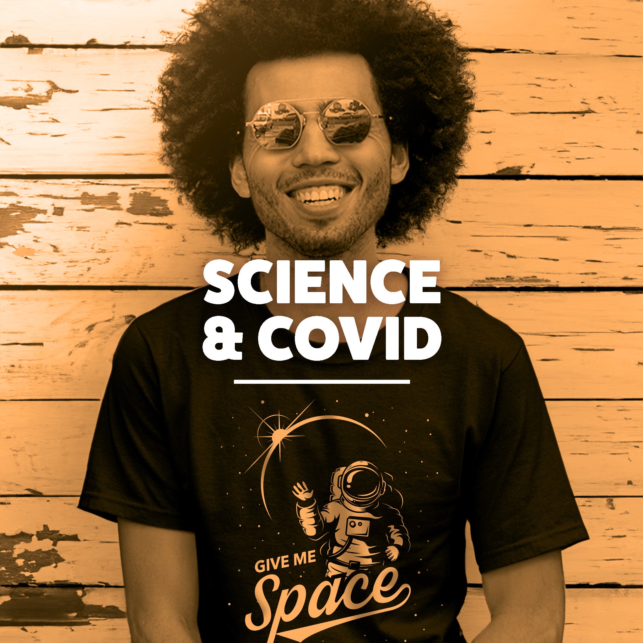 A Black man wearing a t-shirt that features an astronaut in space. The text reads 