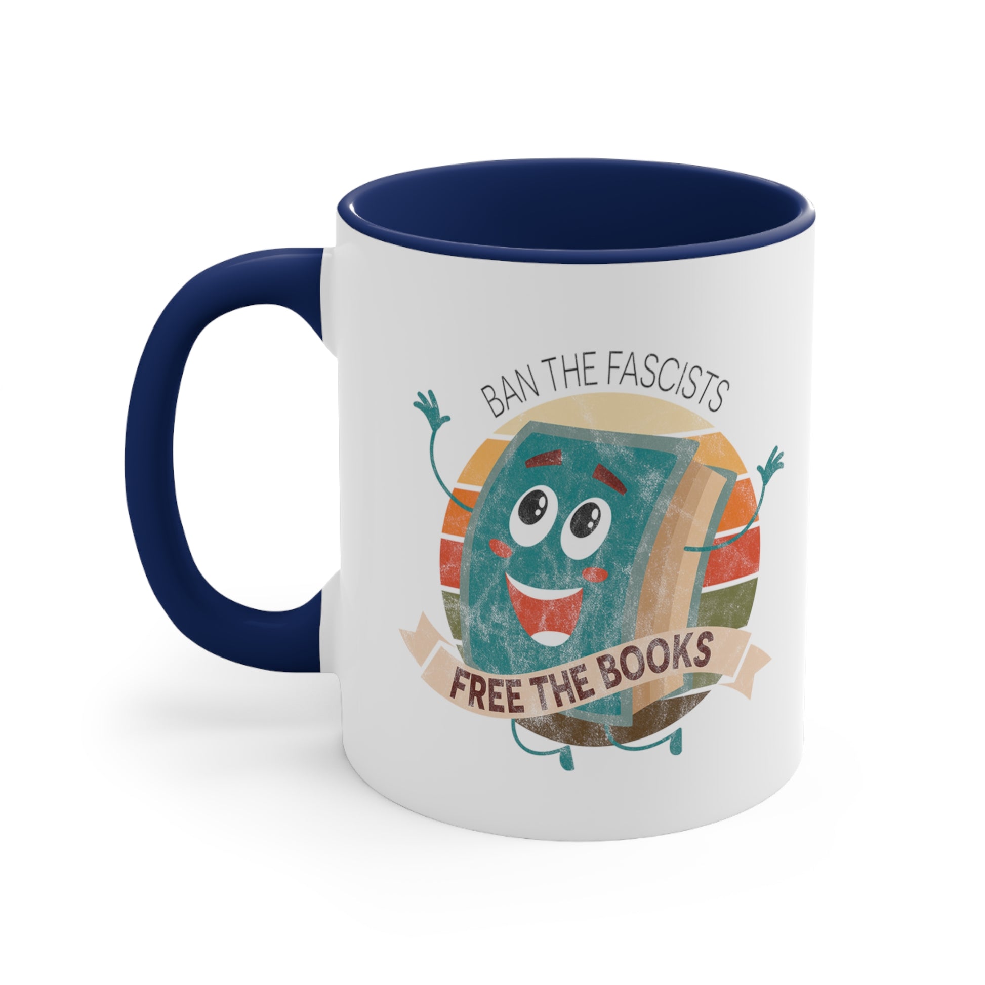 Mug with a navy blue handle and interior with a graphic that says “Ban the Fascists, Free the Books” with a vintage illustration of a cartoon book leaping for joy. There is a circle of vintage-colored stripes behind it. 