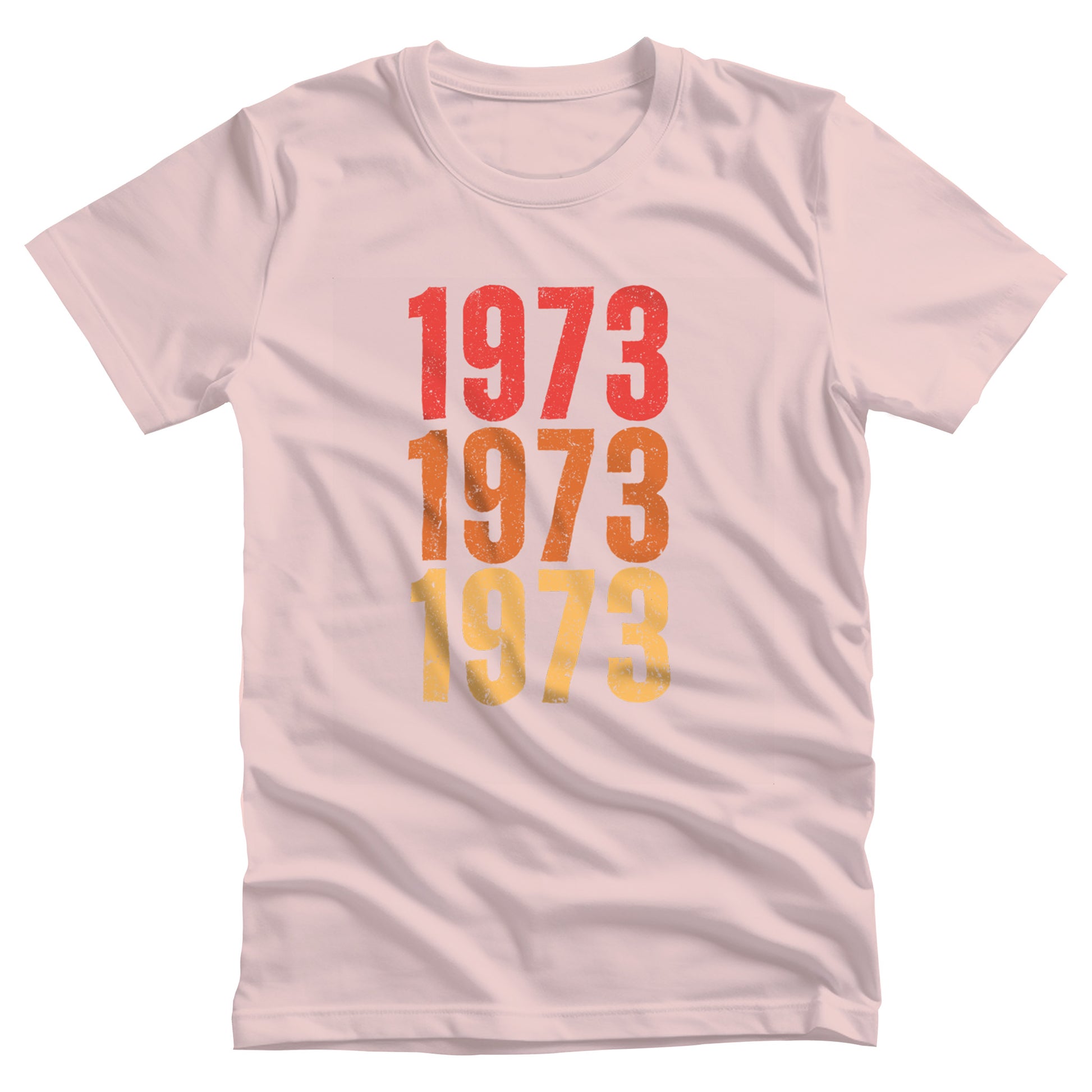 Soft Pink color vintage-style unisex t-shirt with ‘1973” on the front, featuring retro-inspired colors and slight distressing, repeated three times in distinct rows.