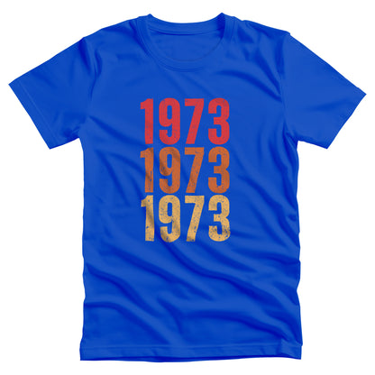 True Royal color vintage-style unisex t-shirt with ‘1973” on the front, featuring retro-inspired colors and slight distressing, repeated three times in distinct rows.