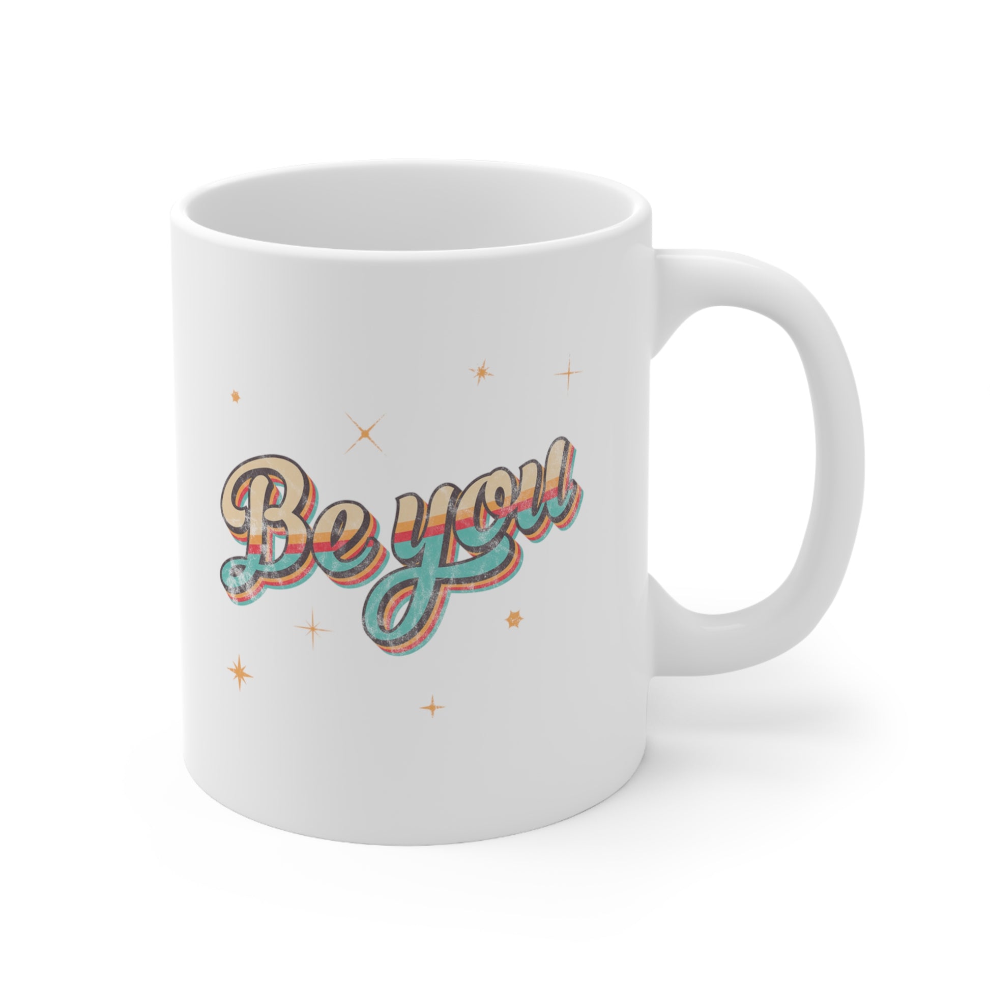 11oz white ceramic mug that says “Be you” in a vintage-inspired script font with vintage colors and stripes. It’s designed to look as if small parts of the design are coming off of the mug.