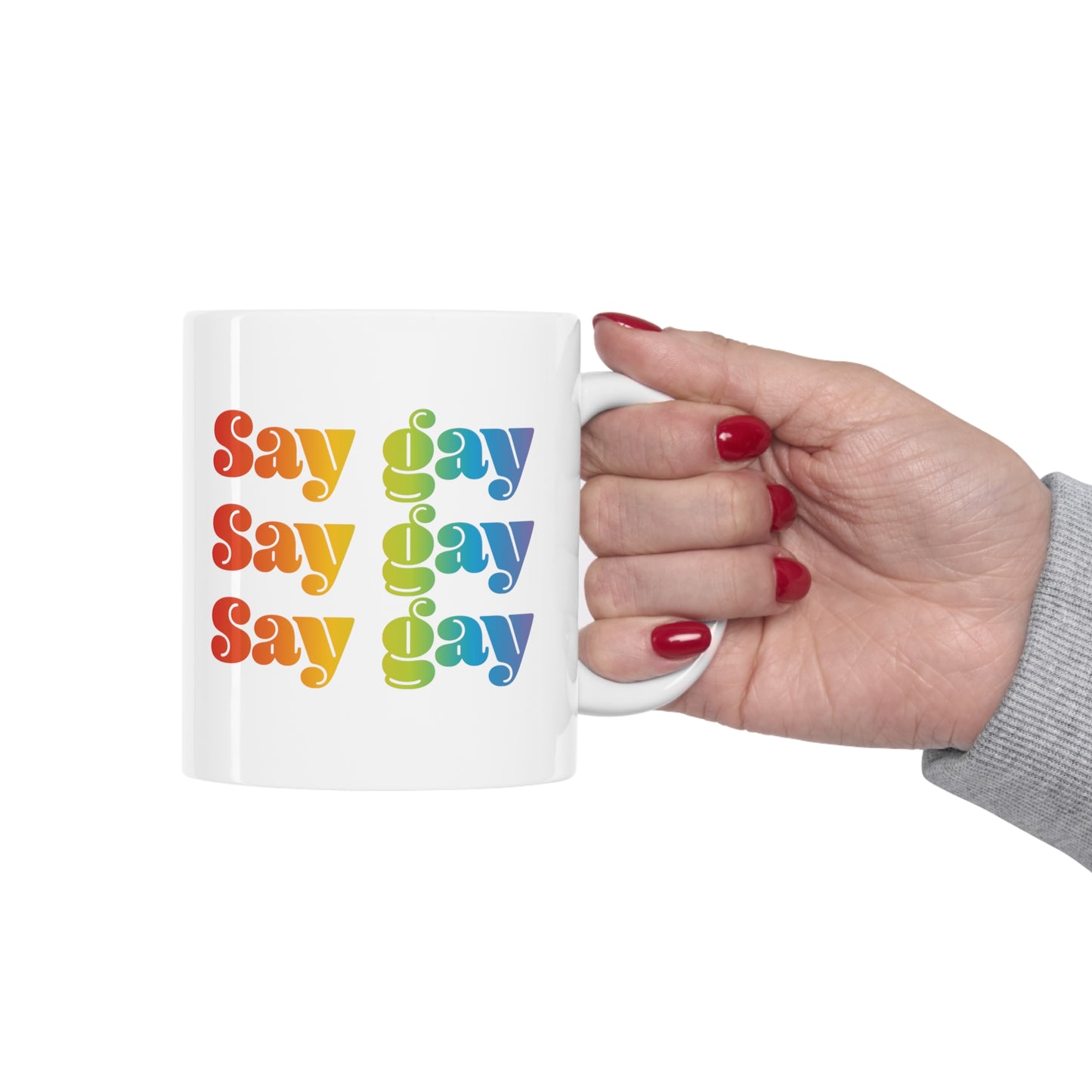 11oz white ceramic mug that reads “Say gay” x3 rows in a thick, rainbow font.