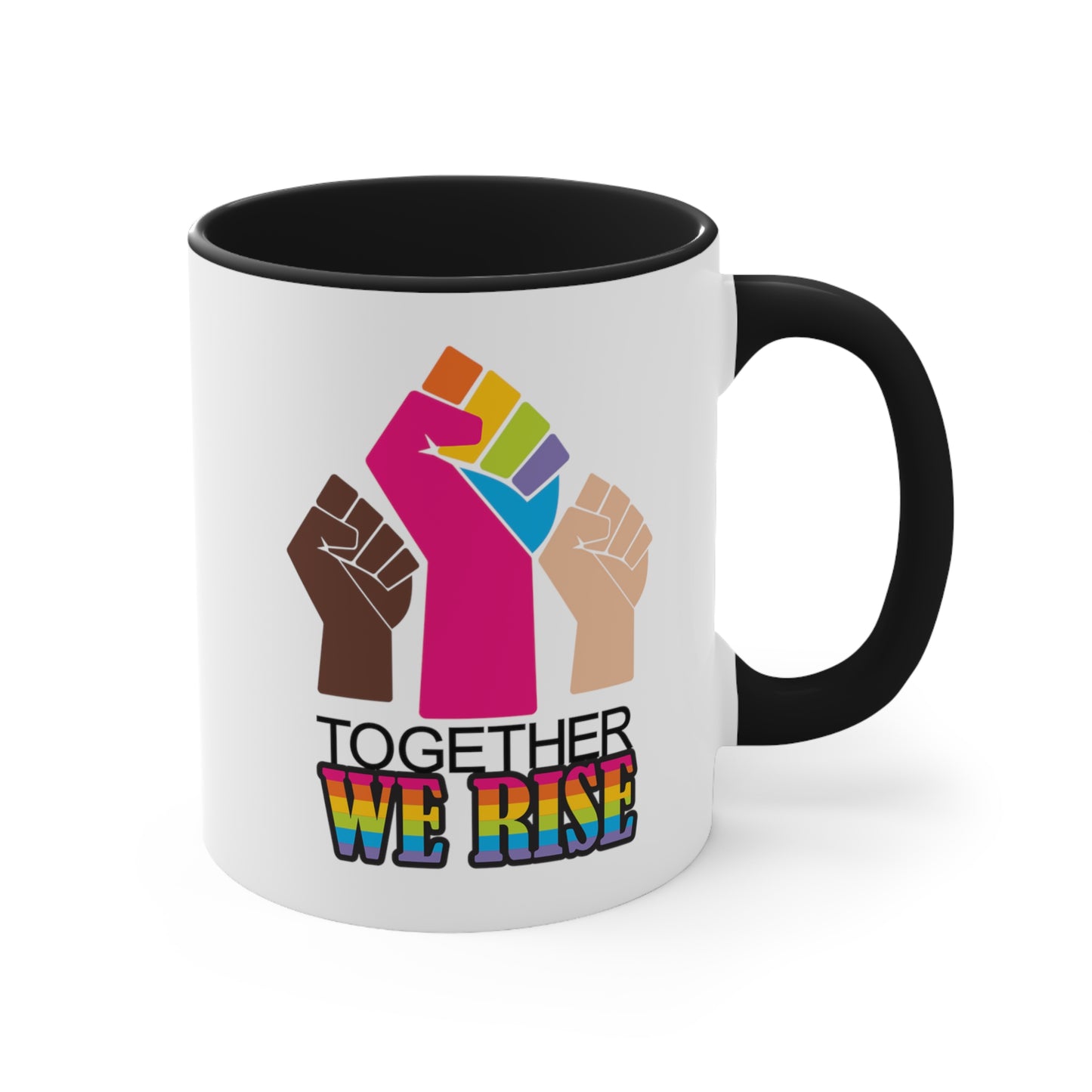 Black accented 11oz ceramic mug ]with a graphic a brown skin-colored fist on the left, a rainbow fist front and center, and a white skin-colored fist on the right. Below that reads “Together We Rise.” “Together” is on one line and “We Rise” is below that in rainbow colors. The inside of the mug and the handle are both black.