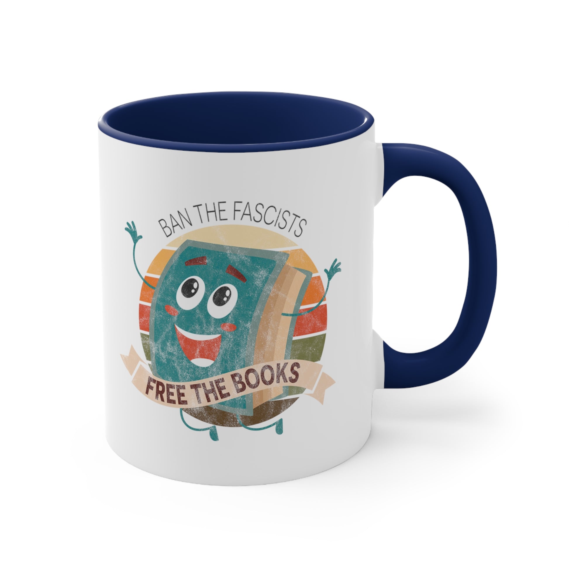 Mug with a navy blue handle and interior with a graphic that says “Ban the Fascists, Free the Books” with a vintage illustration of a cartoon book leaping for joy. There is a circle of vintage-colored stripes behind it. 