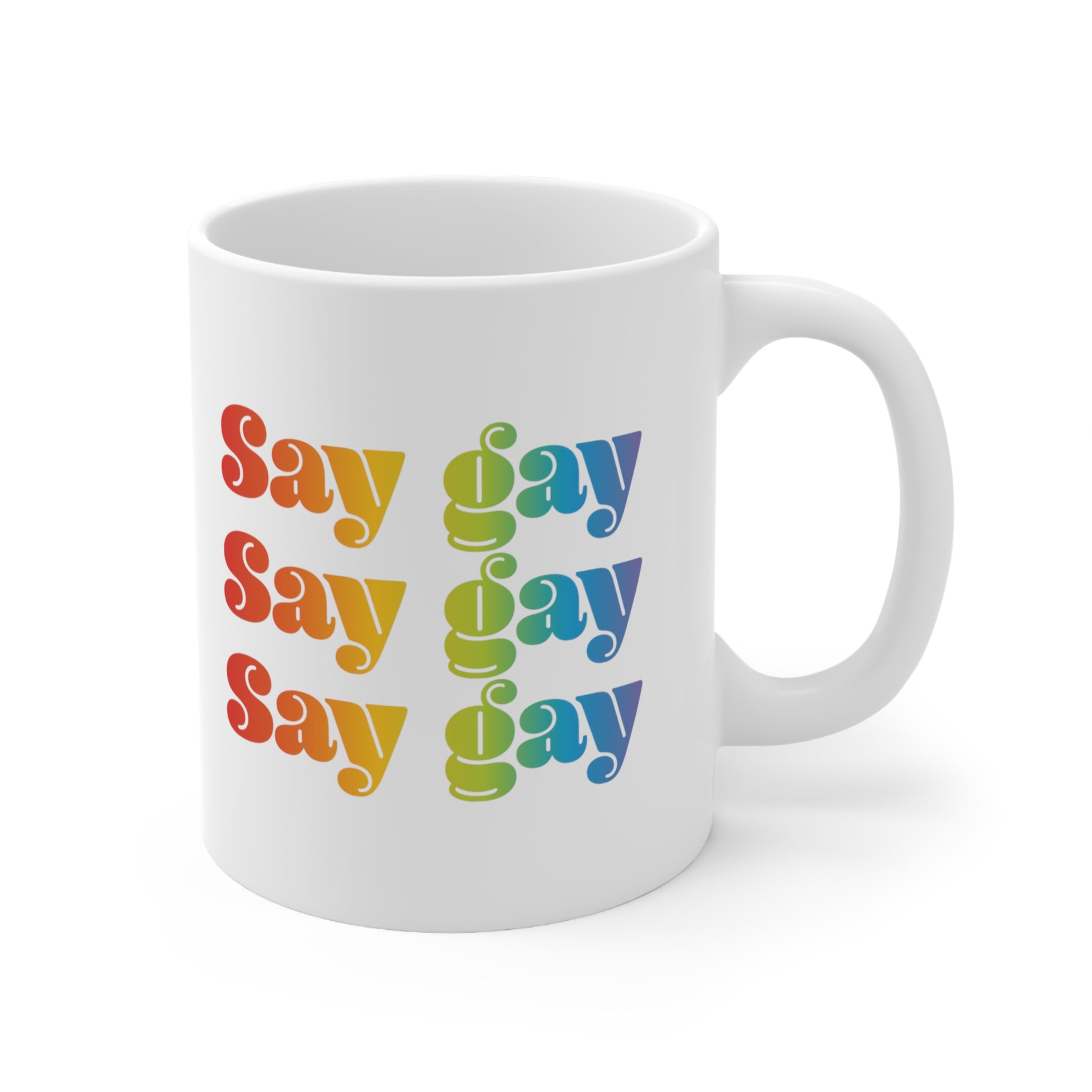 11oz white ceramic mug that reads “Say gay” x3 rows in a thick, rainbow font.