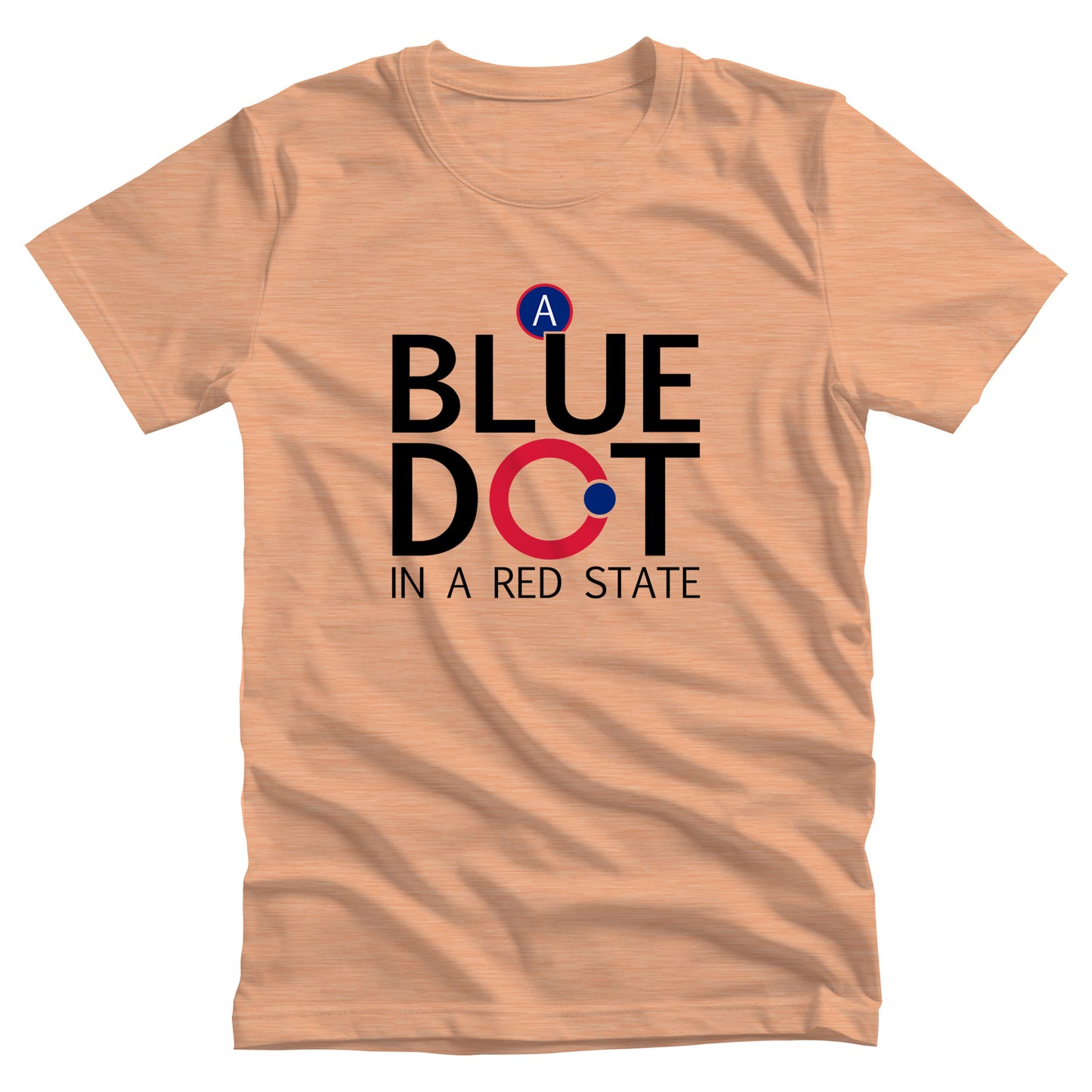  Heather Peach unisex t-shirt that says, “A Blue Dot in a Red State” in all caps. “A Blue Dot” are all on their own line, and “A Red State” is on its own line. The “O” in “Dot” is red with a small blue dot on the outer edge