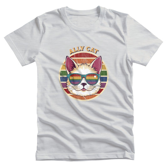 Ash color unisex t-shirt with a circular retro-inspired image of a cat wearing rainbow sunglasses with a retro sunset made from parallel lines behind it. The text reads “ALLY CAT” in all caps, arched over the image. The graphic has a retro, worn texture.