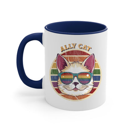 11oz ceramic mug with a navy blue handle and interior with a circular retro-inspired image of a cat wearing rainbow sunglasses with a retro sunset made from parallel lines behind it. The text reads “ALLY CAT” in all caps, arched over the image. The graphic has a retro, worn texture.