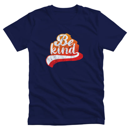 Navy Blue unisex t-shirt that says, “Be Kind” in a script font that is an orange gradient color. The “d” has a unique swoosh glyph extending below the word, adding a dynamic and flowing aesthetic to the text.