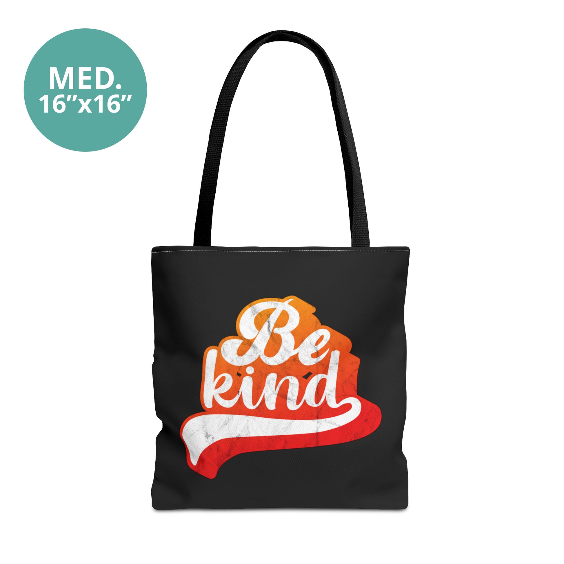 Medium 16x16” black tote bag that says, “Be Kind” in a script font that has an orange gradient. The “d” has a unique swoosh glyph extending below the word, adding a dynamic and flowing aesthetic to the text.