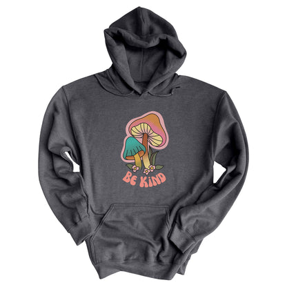 Dark Heather color hoodie that says “Be Kind” in a retro font with two retro mushrooms above the text. The text is slightly arched down.