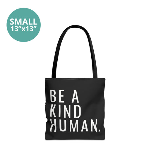 Small 13x13” black tote bag with a black handle featuring the phrase 'Be a kind human.' in white, all caps, left-justified, with a clean, narrow, sans-serif font.