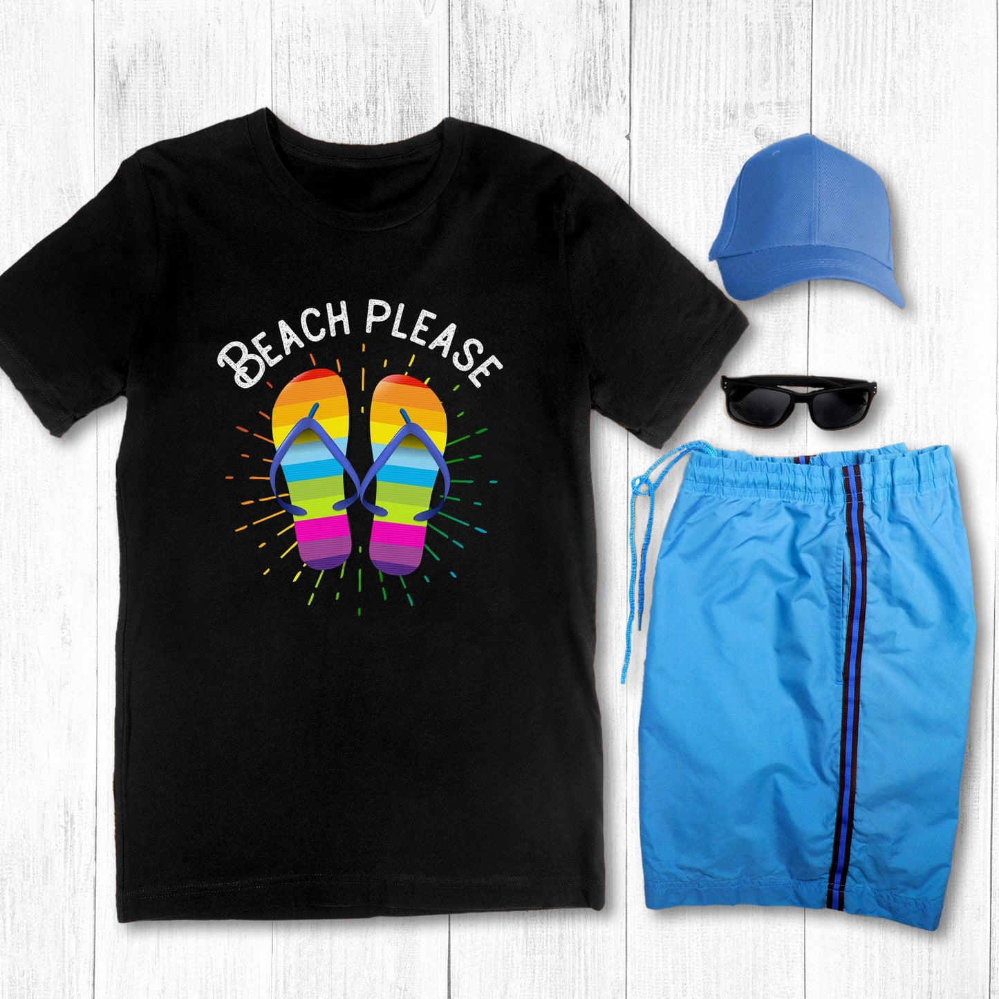 Black color unisex t-shirt that says, “BEACH PLEASE” arched over a graphic of rainbow-colored flip flops with a rainbow gradient starburst behind it.