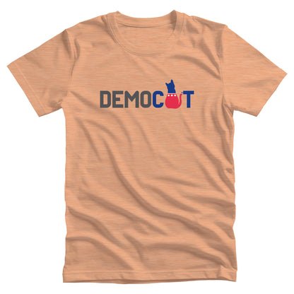 Heather Peach color unisex t-shirt that says “DEMOCAT.” The “A” is an illustration of a cat that’s blue at the top and red at the bottom.