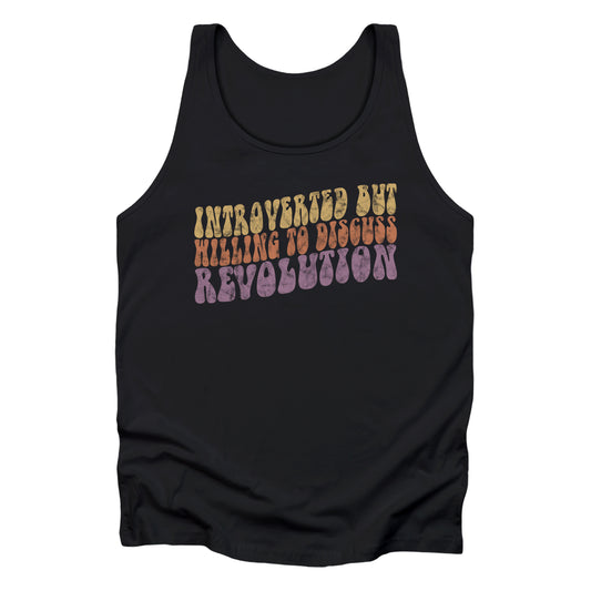 Black unisex tank top with a vintage graphic on it that looks worn and grungy. The graphic says “Introverted but willing to discuss revolution” in a retro font in all caps. Each line is a different color: “Introverted but” is a retro yellow, “willing to discuss” is a retro red, and “Revolution” is a retro purple. The graphic is a wavy shape and slopes upwards to the right.