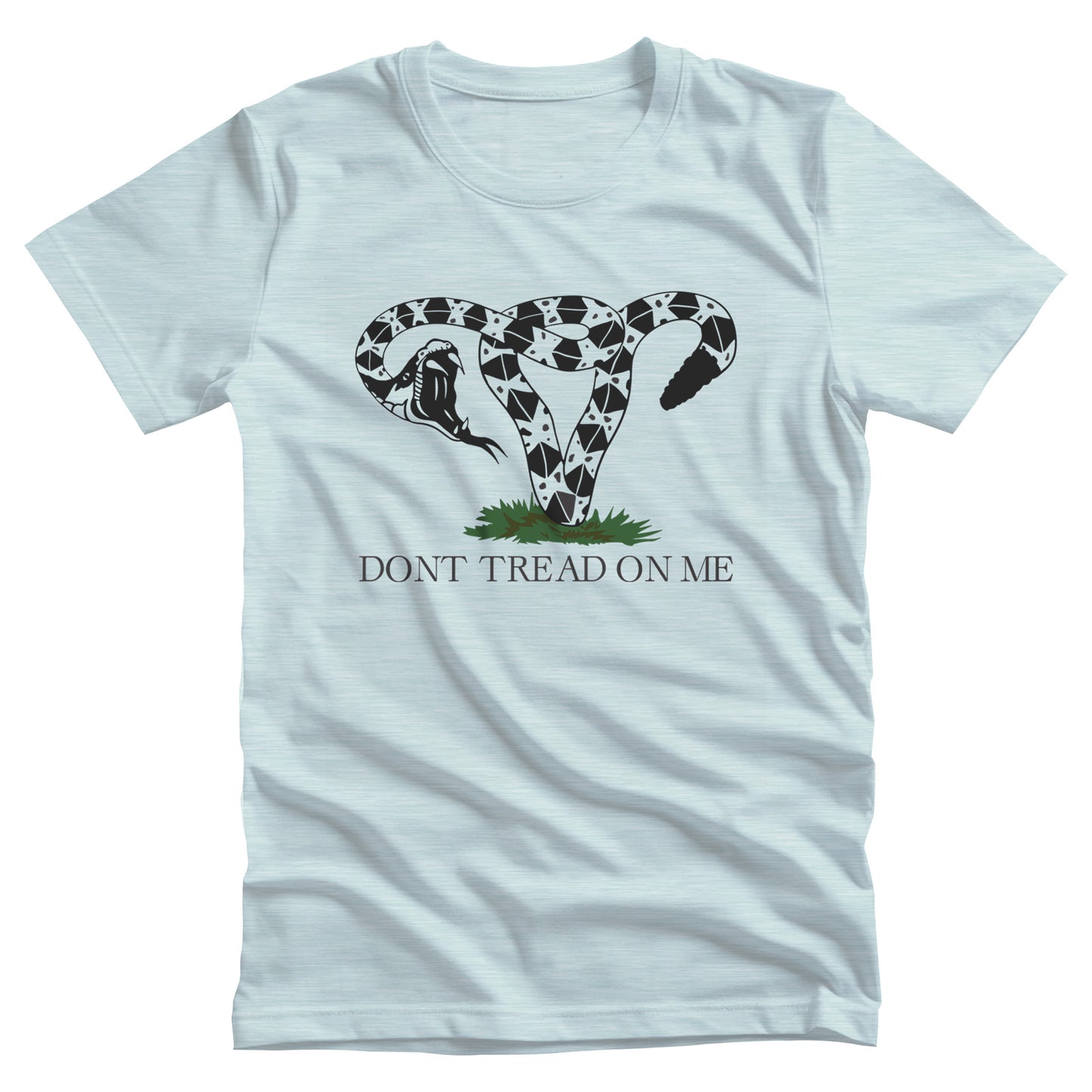 Heather Ice Blue color unisex t-shirt with an image of a rattlesnake coiled into the shape of a uterus. Its mouth is wide open ready to strike. Beneath the graphic, it says, “DONT TREAD ON ME” with no apostrophe in “DON’T” like the original.