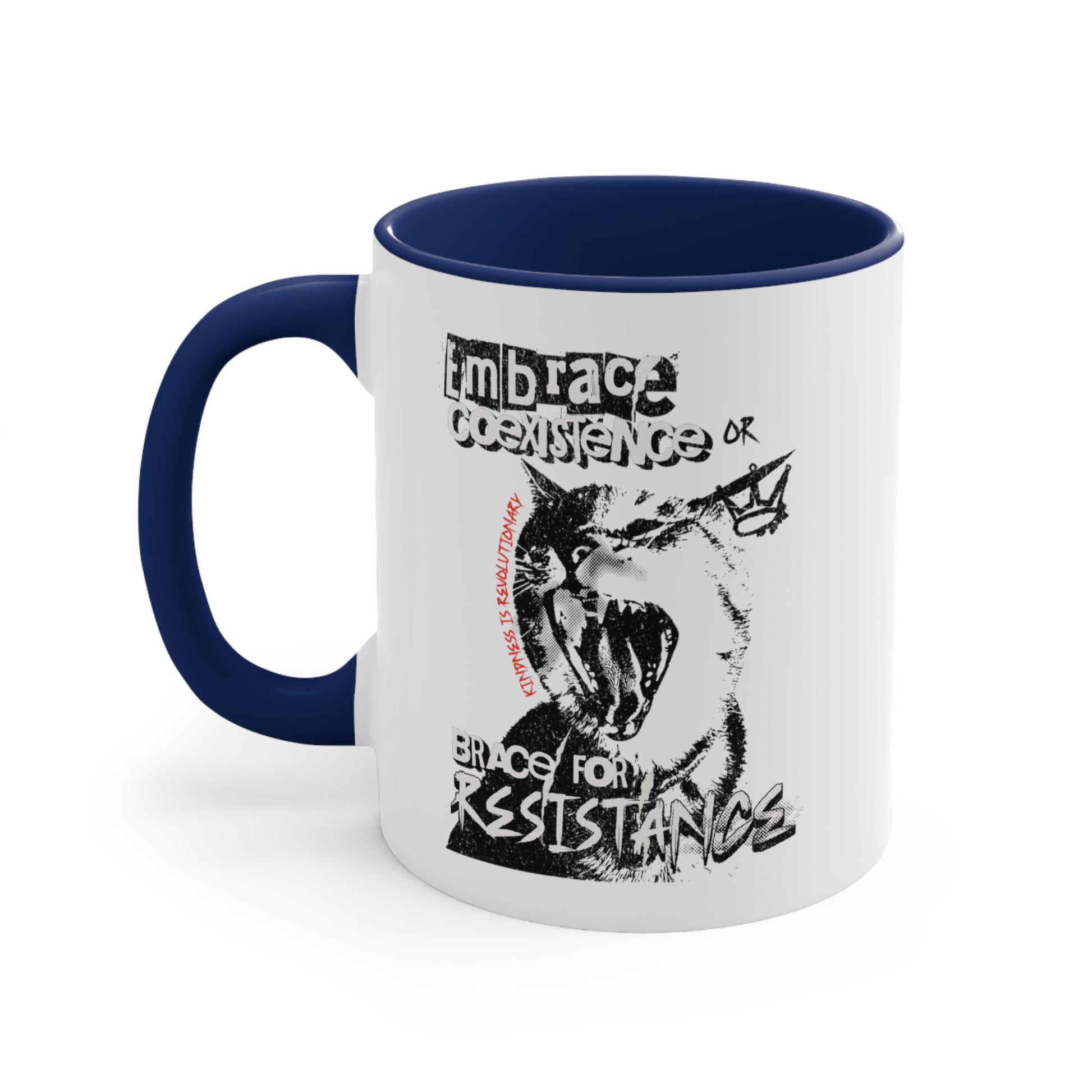 11oz ceramic mug with a navy blue interior and handle featuring the phrase 'Embrace Coexistence or Brace for Resistance' in a grunge font. The shirt includes an illustration of a cat meowing loudly with a small crown to the right, adding to the grunge aesthetic. Small red letters along the left side of the cat's face, written vertically say, ‘Kindness is revolutionary' in all caps.