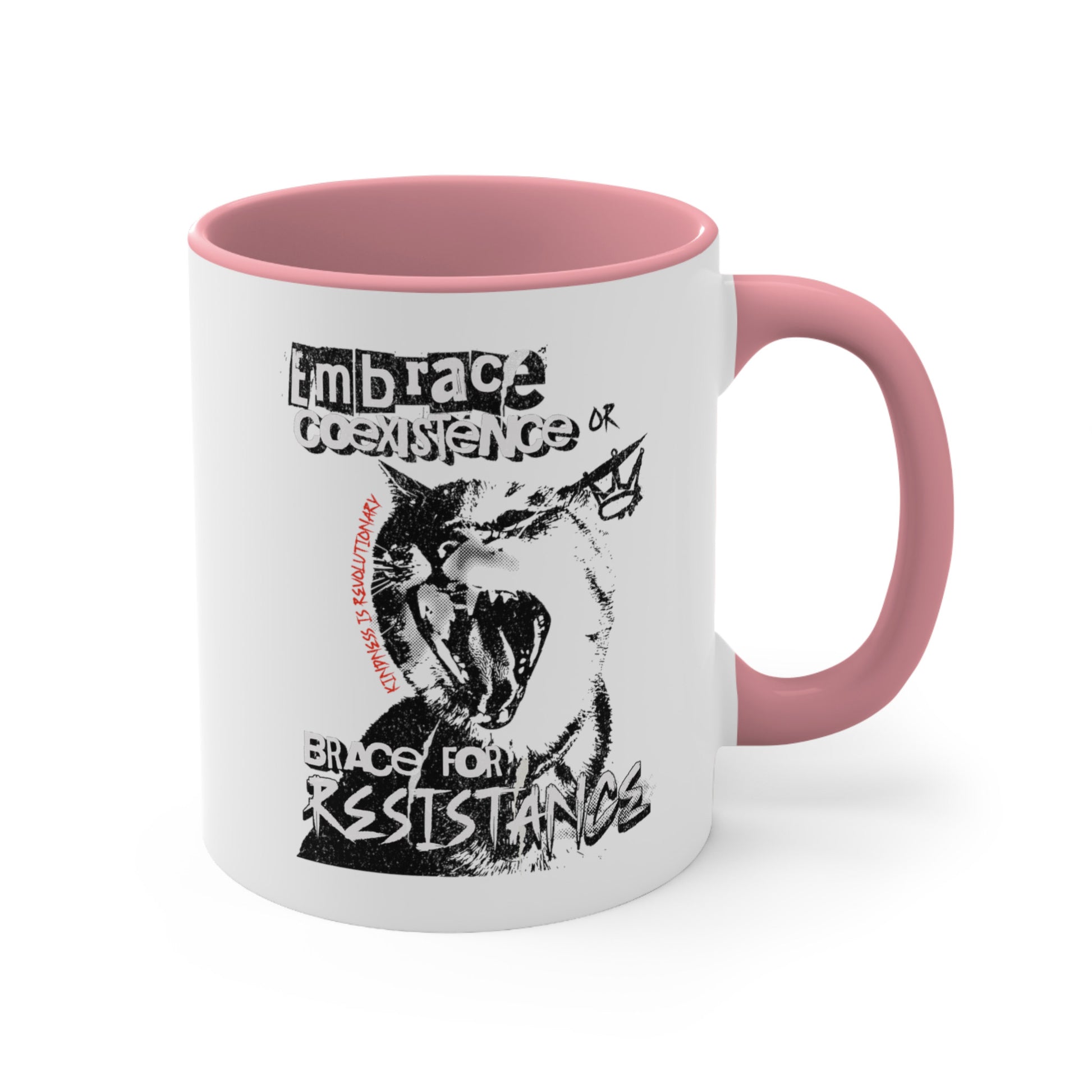 11oz ceramic mug with a pink interior and handle featuring the phrase 'Embrace Coexistence or Brace for Resistance' in a grunge font. The shirt includes an illustration of a cat meowing loudly with a small crown to the right, adding to the grunge aesthetic. Small red letters along the left side of the cat's face, written vertically say, ‘Kindness is revolutionary' in all caps.