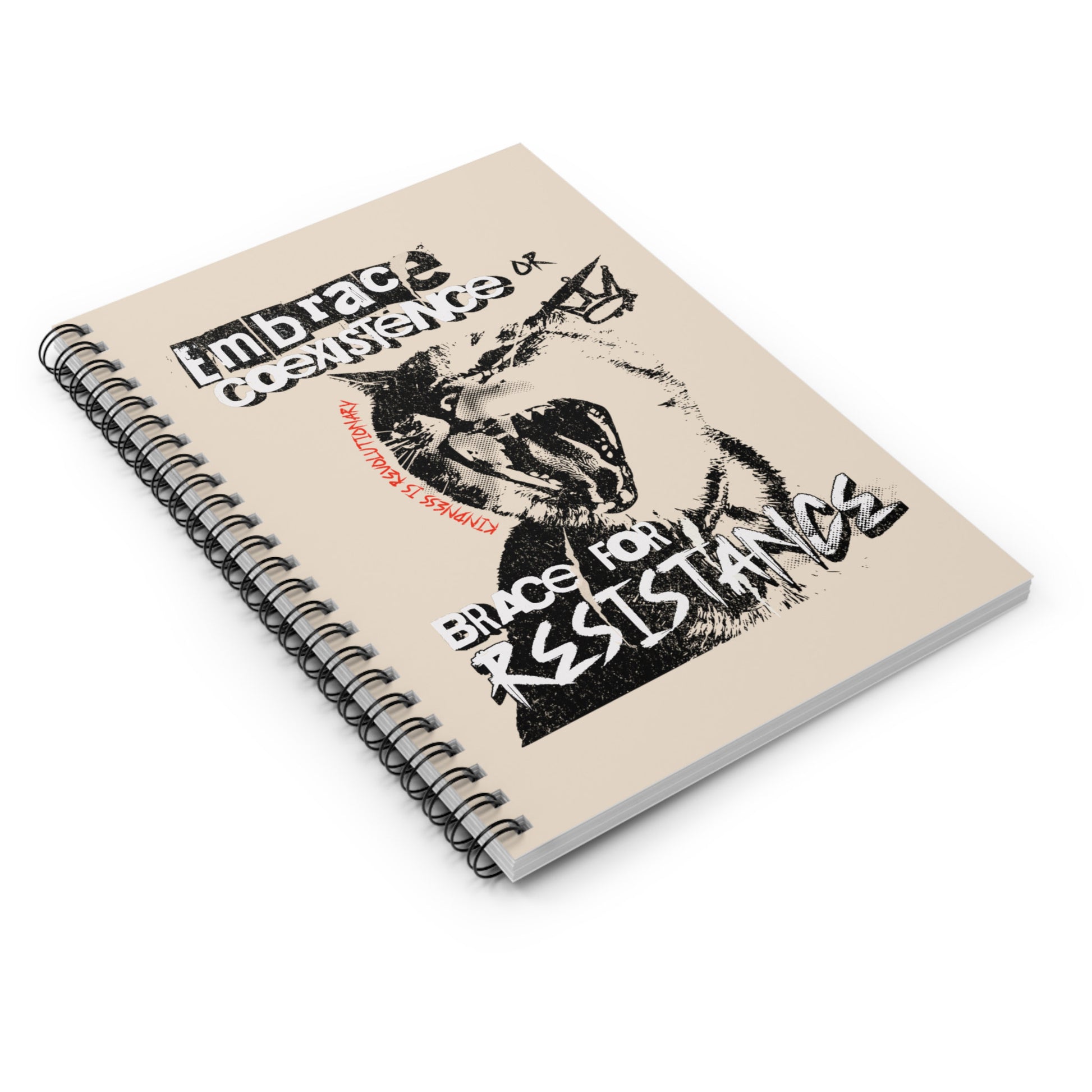 A 118-page spiral-bound notebook with a beige cover featuring the phrase 'Embrace Coexistence or Brace for Resistance' in a grunge font. The shirt includes an illustration of a cat meowing loudly with a small crown to the right, adding to the grunge aesthetic. Small red letters along the left side of the cat's face, written vertically say, ‘Kindness is revolutionary' in all caps.