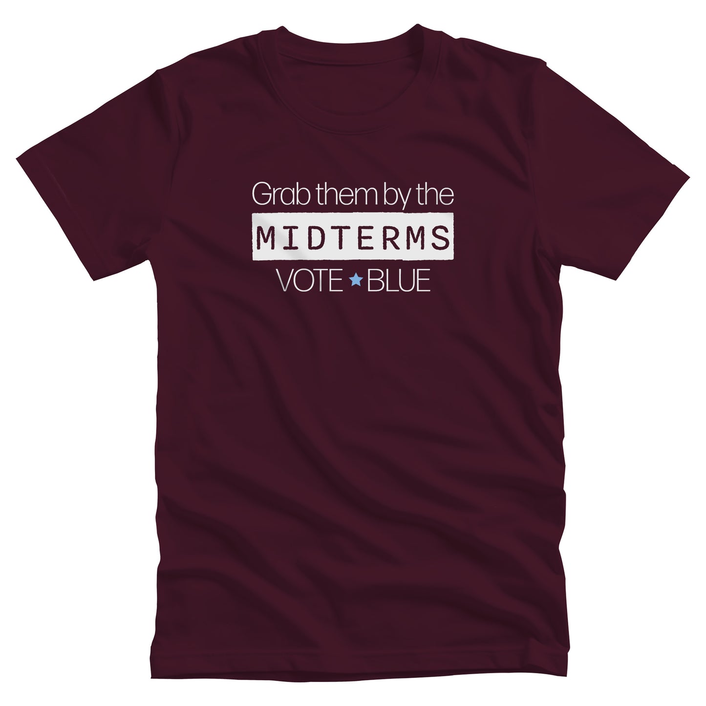 Maroon unisex t-shirt that say, “Grab them by the midterms. Vote Blue.” The word “Midterms” is in a white rectangle. 