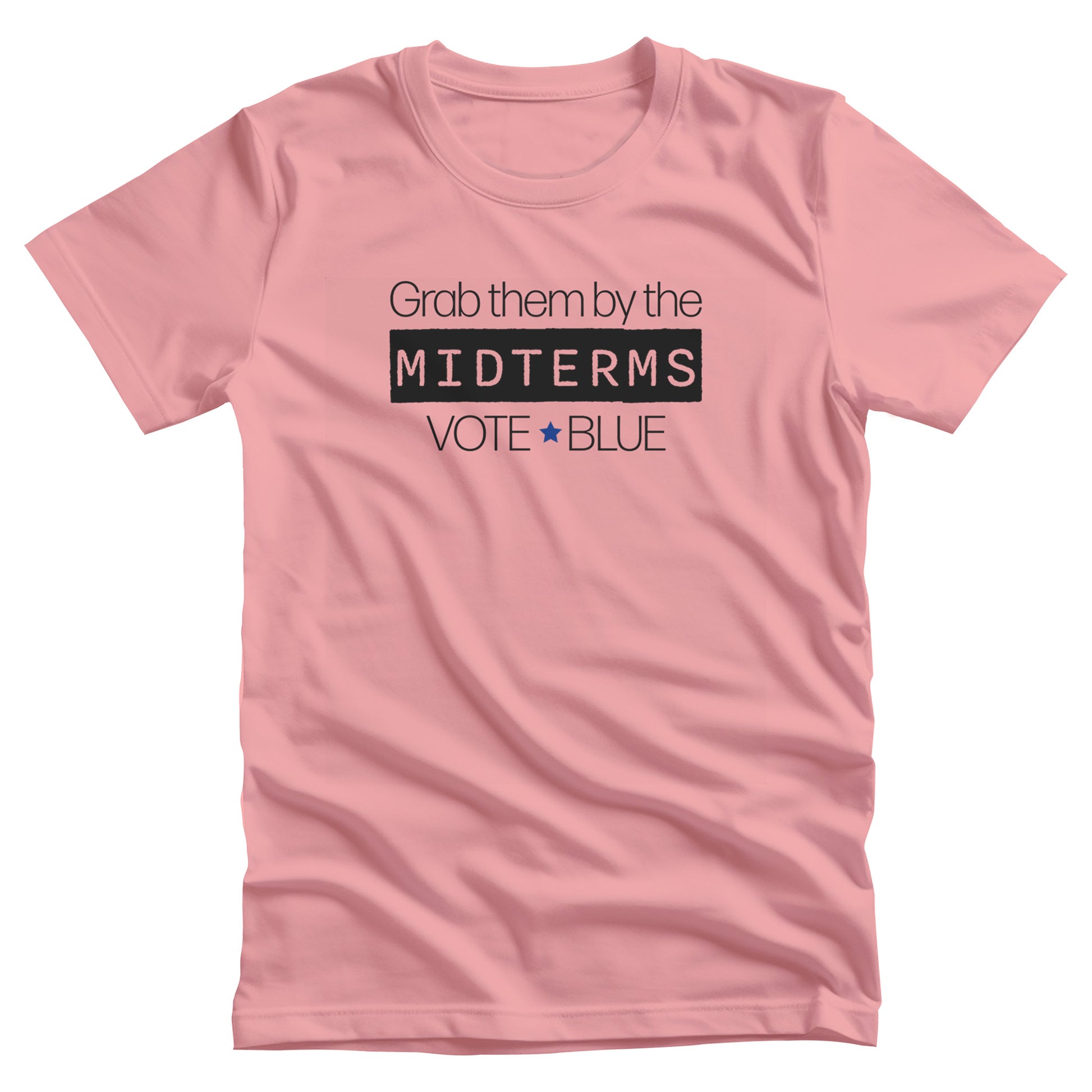 Pink unisex t-shirt that say, “Grab them by the midterms. Vote Blue.” The word “Midterms” is in a black rectangle. 