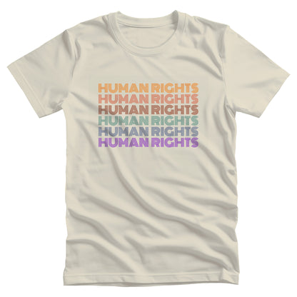 Natural color unisex t-shirt that says, “HUMAN RIGHTS” six times. The first row is yellow, the second row is burgundy/red, the third row is dark maroon, the fourth row is teal, the fifth row is dark blue, and the last row is purple.