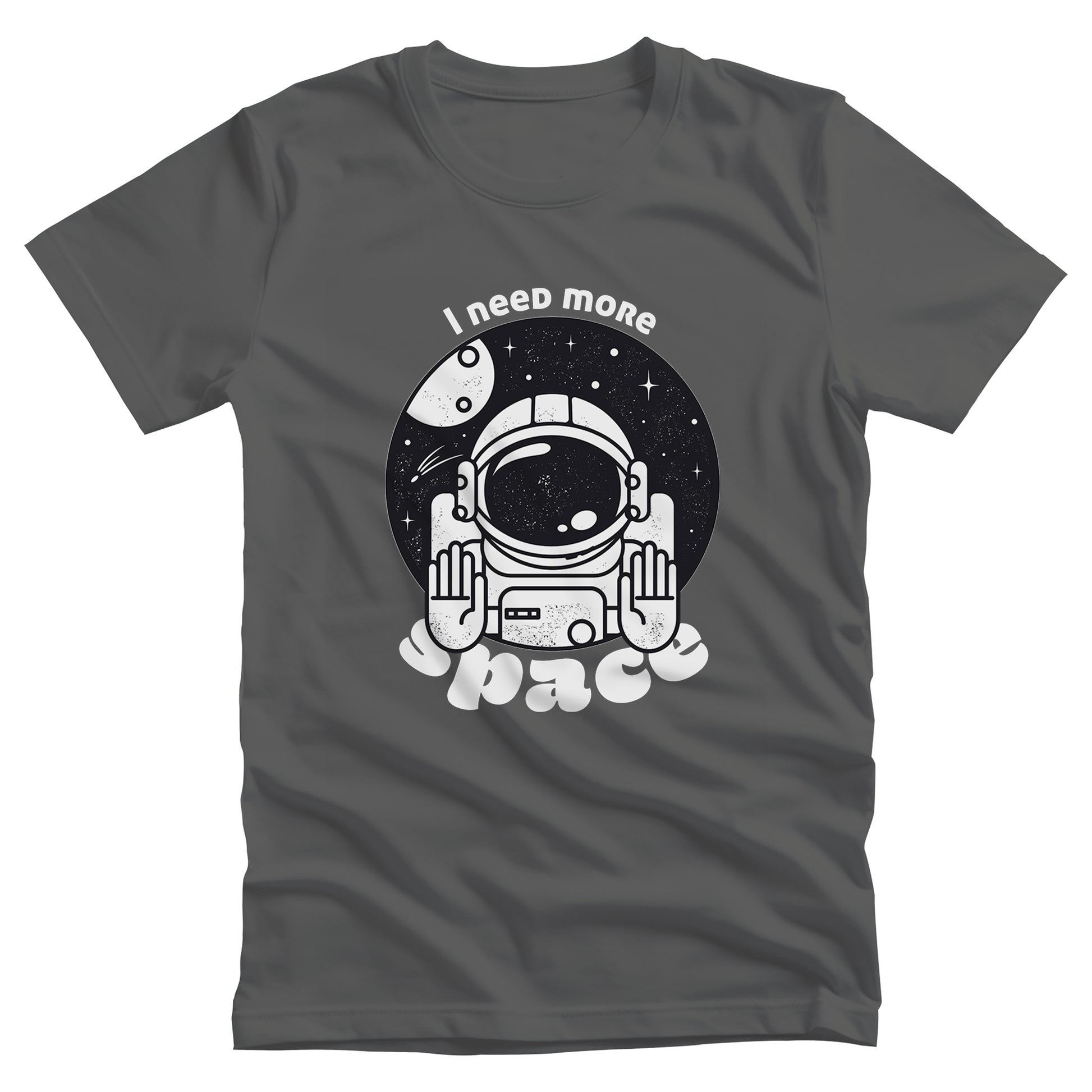 Asphalt color unisex t-shirt that says, “I need more space”. The text is a retro font. There is a graphic of an astronaut inside a circle with their hands in the stop position. “I need more” is arched over the graphic, and “space” is reverse-arched over the bottom of the graphic.