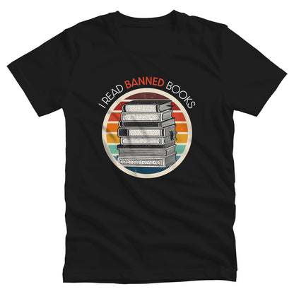 Black unisex t-shirt with a circular graphic of stacked old books with a vintage sunset made from horizontal lines behind it. “I READ BANNED BOOKS” is arched over the graphic with the word. “BANNED” an orange color.