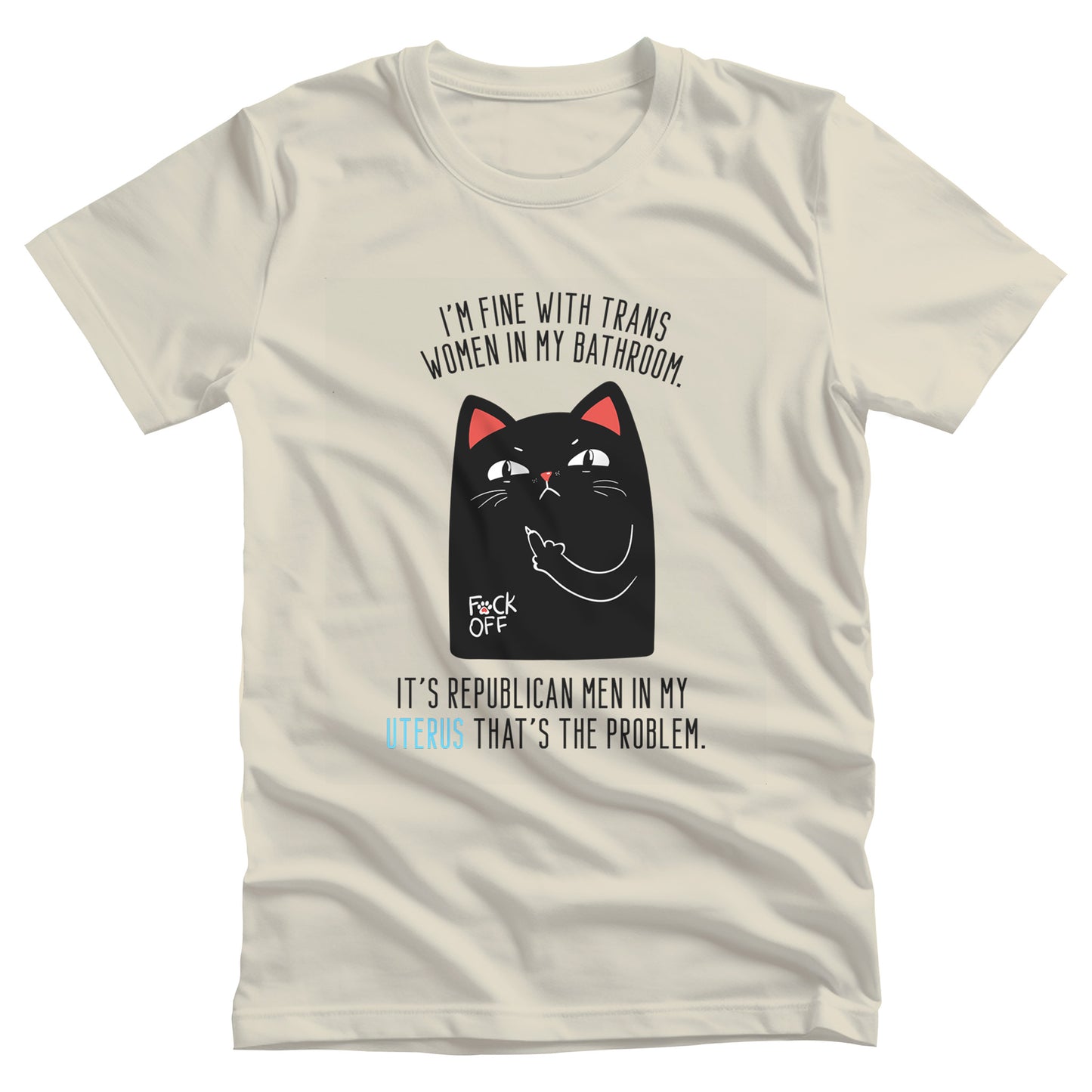 Natural color unisex t-shirt with a graphic of an annoyed cat showing its middle finger. The text says “I’m fine with trans women in my bathroom” above the graphic, slightly arched. Below the graphic reads “It’s Republican men in my uterus that’s the problem.”