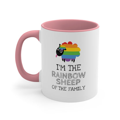 11oz ceramic mug with a pink handle and interior that says, “I’m the rainbow sheep of the family” with a graphic of a rainbow-colored sheep above it.