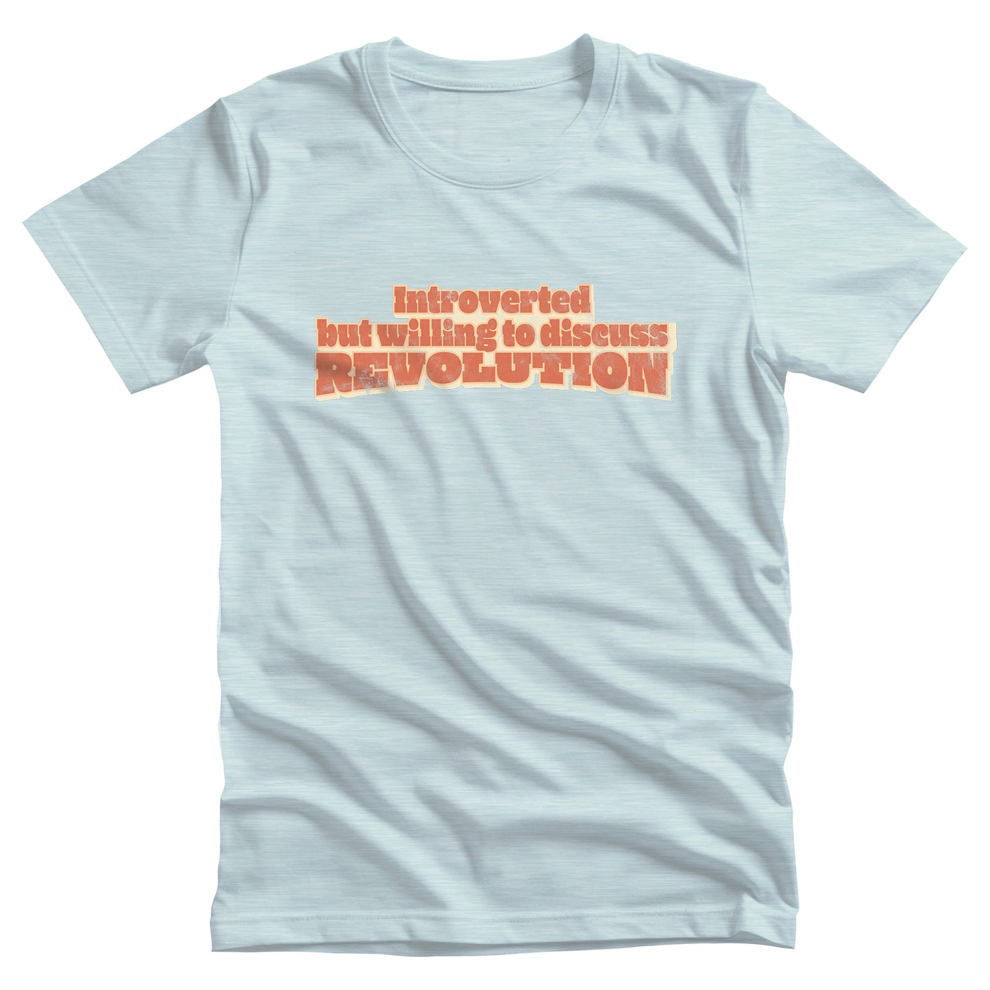 Heather Ice Blue color unisex t-shirt that says “Introverted but willing to discuss revolution.” The text is retro-inspired and has a distressed look.