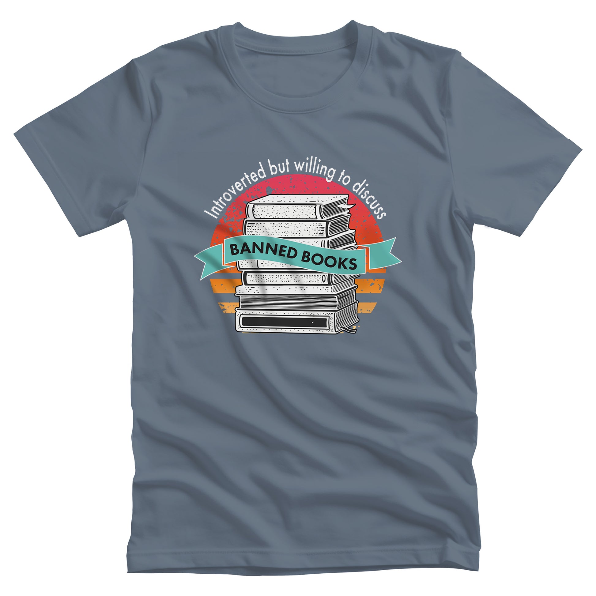 Steel Blue color unisex t-shirt with a graphic that says, “Introverted but willing to discuss banned books.” The image has stacked books with a circular retro sunset behind it. “Introverted but willing to discuss” is arched over the graphic, and “banned books” is inside a wavey blue-green colored ribbon.