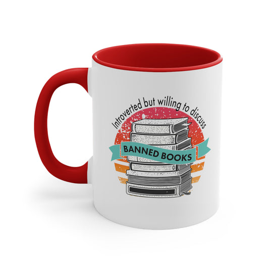 11oz ceramic mug with a red interior and handle that says, “Introverted but willing to discuss banned books.” The background is a retro sunset with a stack of books in the front. The text is arched over the graphic with “Banned Books” being in a turquoise ribbon in the center of the graphic.