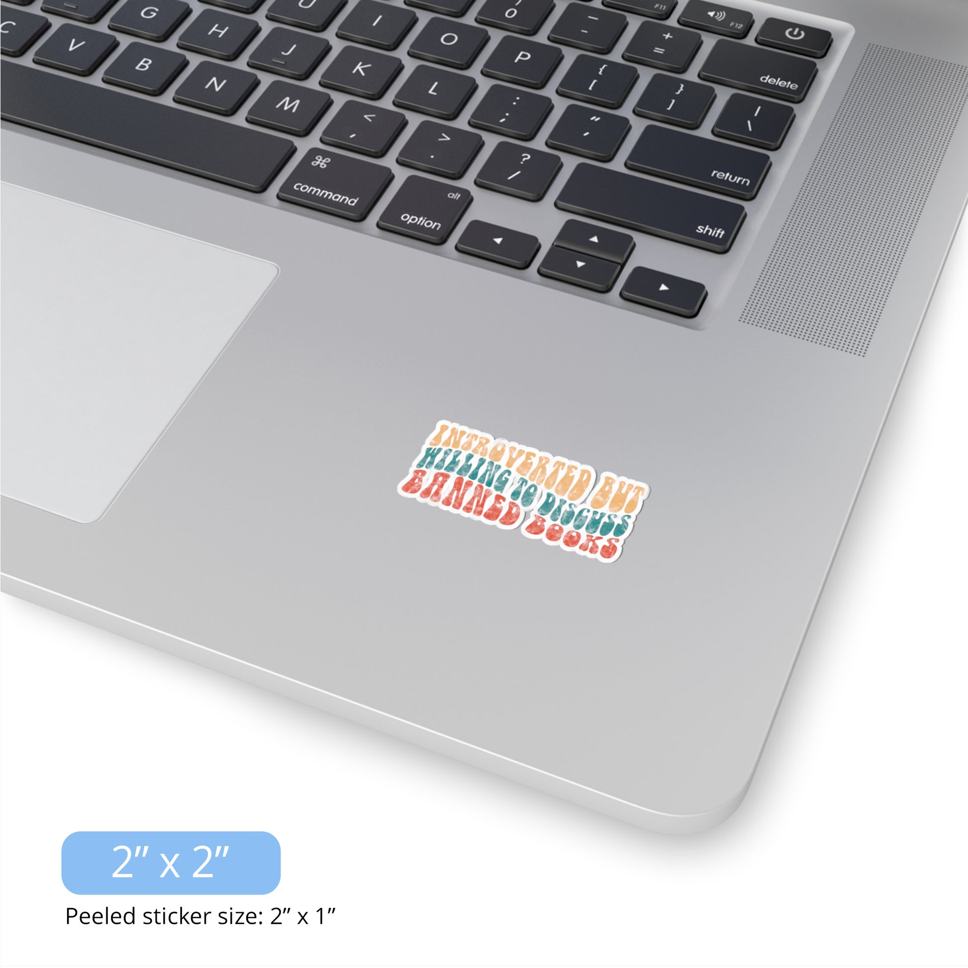 Contextual photo of the 2x2 inch (2x1” peeled) kiss-cut sticker that says “Introverted but willing to discuss banned books” in a retro, 1970s bubble font. Each line is a different color. The graphic is slightly distressed.