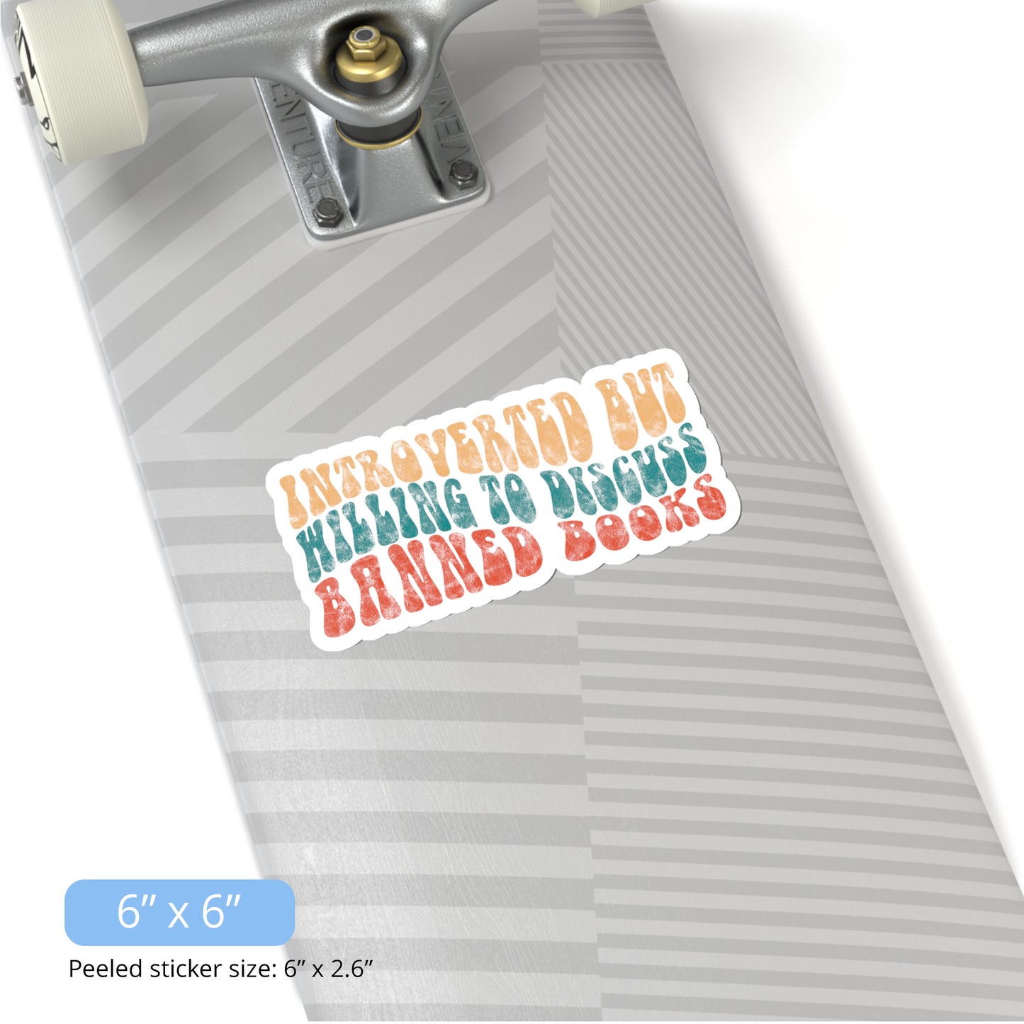 Contextual photo of the 6x6 inch (6x2.6” peeled) kiss-cut sticker that says “Introverted but willing to discuss banned books” in a retro, 1970s bubble font. Each line is a different color. The graphic is slightly distressed.