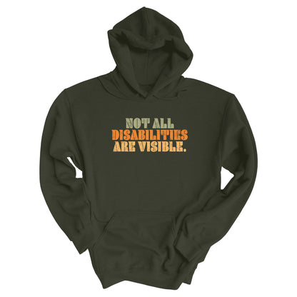 Military Green color hoodie that says, “Not all disabilities are visible” in a thick, retro font in all caps. Each line is a different color. “Not all” is light green, “disabilities” is orange, and “are visible” is yellow. The graphic has a retro look and is slightly distressed.