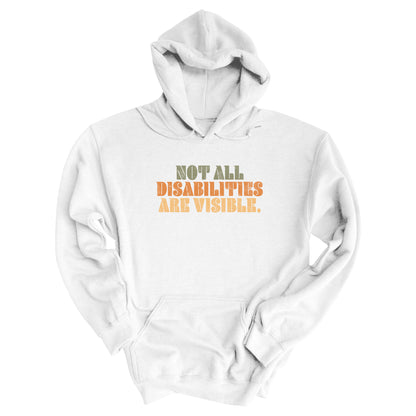 White hoodie that says, “Not all disabilities are visible” in a thick, retro font in all caps. Each line is a different color. “Not all” is light green, “disabilities” is orange, and “are visible” is yellow. The graphic has a retro look and is slightly distressed.