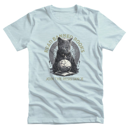 Heather Ice Blue color unisex t-shirt with a graphic of a cat sitting over a globe and an open book. The text says “Read banned books” arched over the top of the cat and “Join the resistance” in a line under the graphic. The text is in all caps.