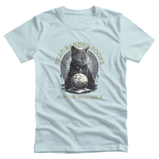 Heather Ice Blue color unisex t-shirt with a graphic of a cat sitting over a globe and an open book. The text says “Read banned books” arched over the top of the cat and “Join the resistance” in a line under the graphic. The text is in all caps.