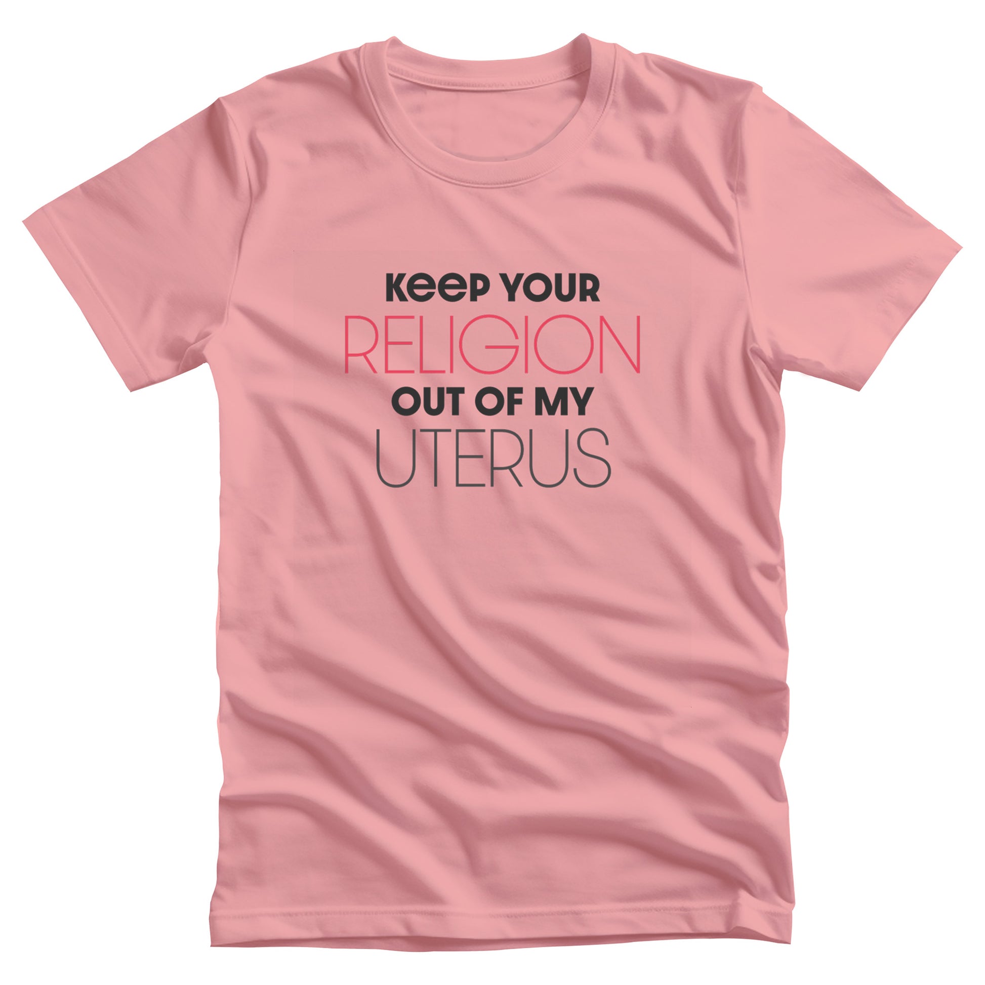 Pink unisex t-shirt that says, “Keep Your Religion Out of My Uterus” in all caps. “Keep Your” is bold, “Religion” is on the next line, is a larger size, and is red, “out of my” is beneath that and in bold, and “uterus” is on the last line