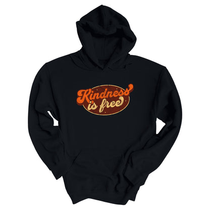 Black unisex hoodie with a retro graphic that says “Kindness is free.” The text is in a script font with a brown oval behind it. The “k” and the “s” in the word “Kindness” are not contained inside the oval. The graphic is also distressed to add to the retro feel.