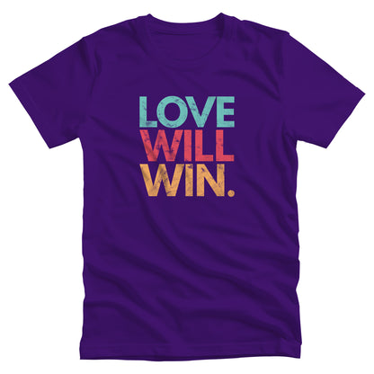 Team Purple color t-shirt with a graphic that says “Love will win.” in all caps. Each word is on its own line and is a different color. “Love” is greenish-blue, “Will” is red, and “Win.” is yellow. The graphic has a faded and slightly grungy/worn look.