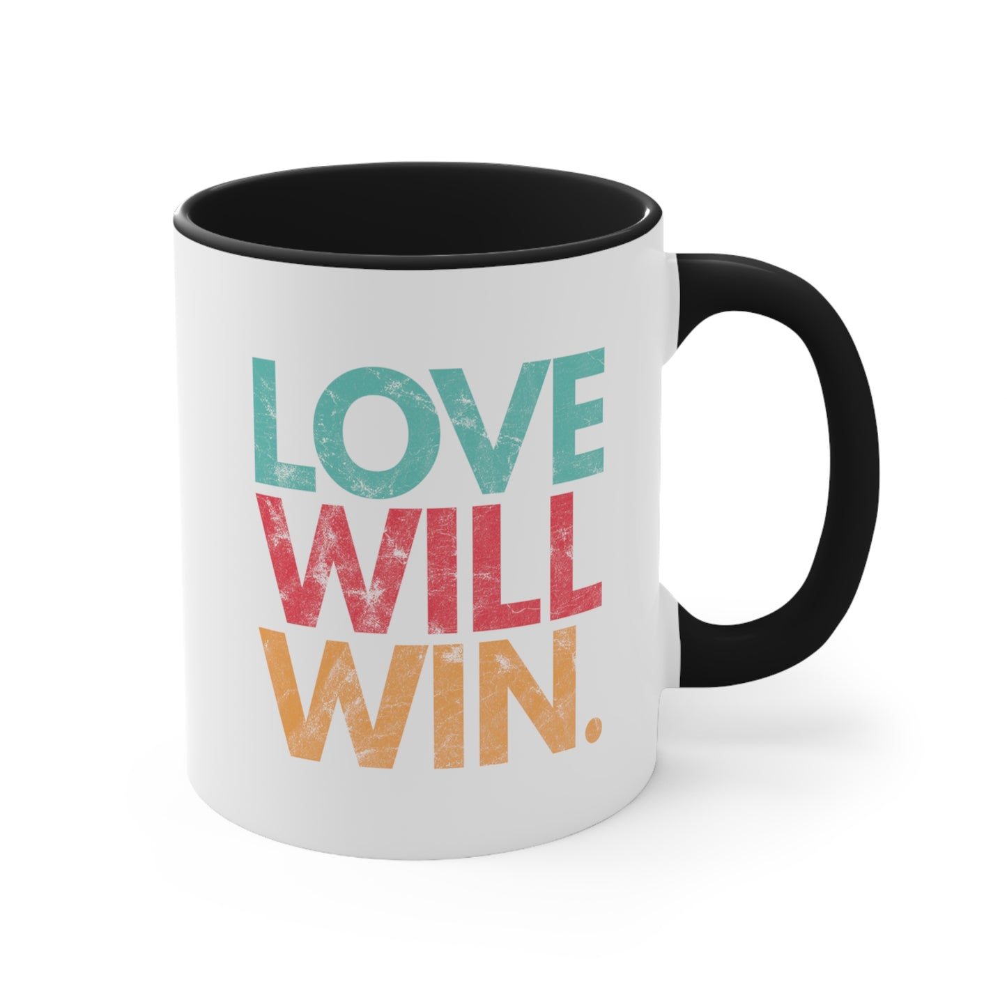 11oz ceramic mug with a black handle and interior with a graphic that says “Love will win.” in all caps. Each word is on its own line and is a different color. “Love” is greenish-blue, “Will” is red, and “Win.” is yellow. The graphic has a faded and slightly grungy/worn look.