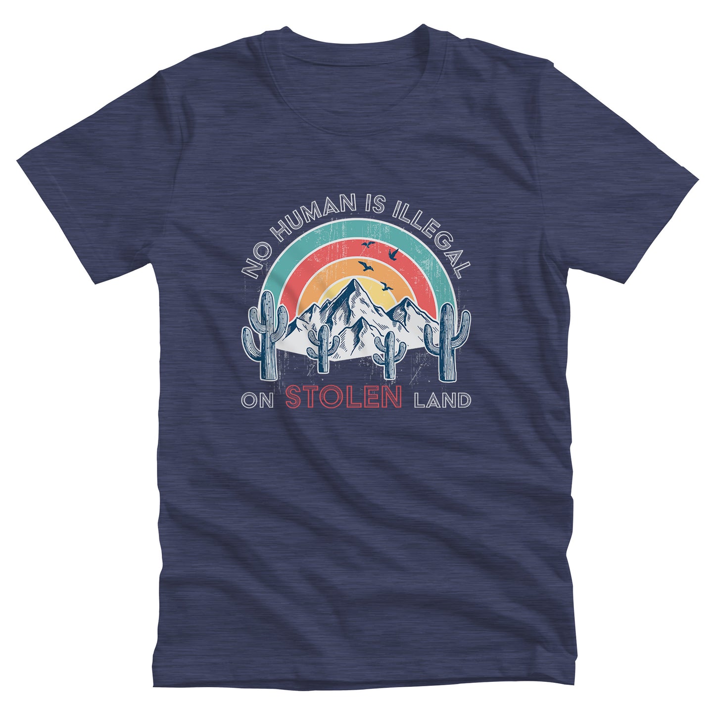 Heather Navy color unisex t-shirt that says, “No Human is Illegal on Stolen Land” arched over a retro sunset with mountains and cactuses in the front. “No Human is Illegal” is arched over the top of the graphic and “on Stolen Land” is on one horizontal line beneath the graphic. The whole image is slightly distressed.