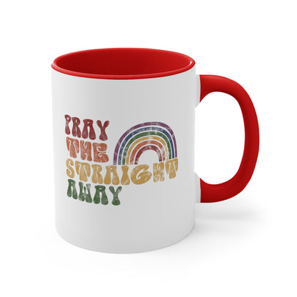 11oz ceramic mug with a red interior and handle that says, “PRAY THE STRAIGHT AWAY” in a retro font. Each word is a different retro color and on its own line. “PRAY” is maroon, “THE” is orange, “STRAIGHT” is yellow, and “AWAY” is green. The words are stacked and left-aligned with a rainbow graphic that has matching colors nestled after the word “THE” over the word “STRAIGHT.”