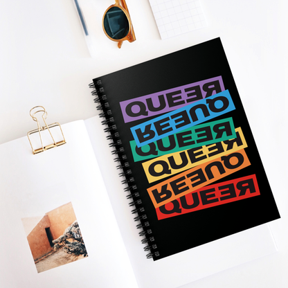 Contextual photo of a spiral ruled-line notebook that artistically expresses the word “Queer.” Each variation of the word is black text in a rectangular block and stacked vertically at a slightly different angle than the next row/block. Sometimes “Queer” is backward, sometimes upside down, and sometimes 1-2 letters are backward. The color blocks are purple, blue, green, yellow, and red.