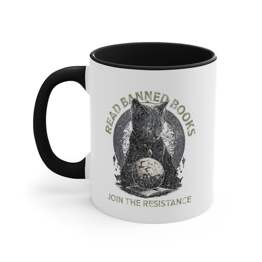 11oz ceramic mug with a black interior and handle with a graphic of a cat sitting over a globe and an open book. The text says “Read banned books” arched over the top of the cat and “Join the resistance” in a line under the graphic. The text is in all caps.